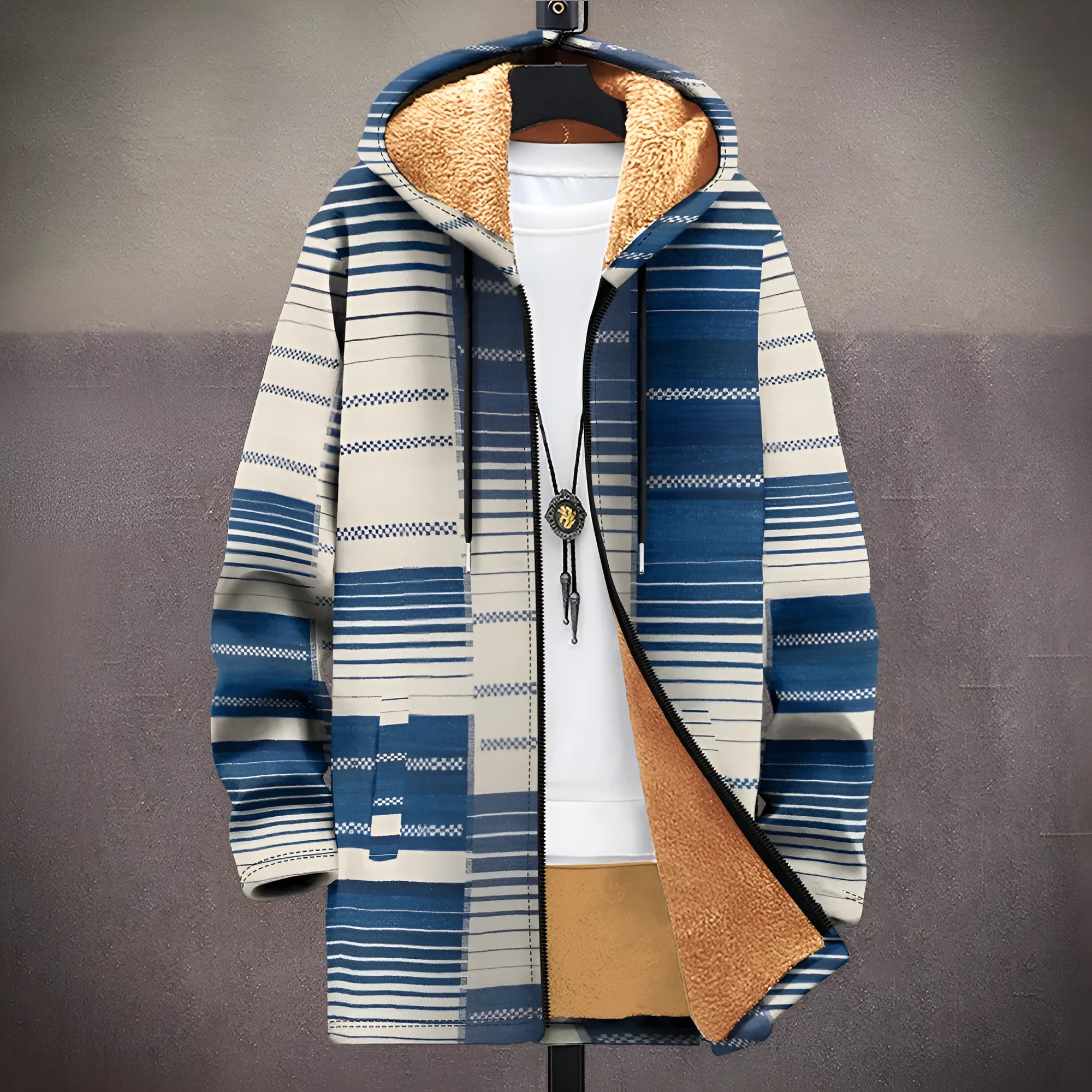 Man wearing a loose multicolour printed hooded cardigan with a front zip.