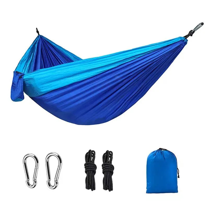 Blue nylon parachute cloth outdoor hammock hung between two trees showing full 270 cm length