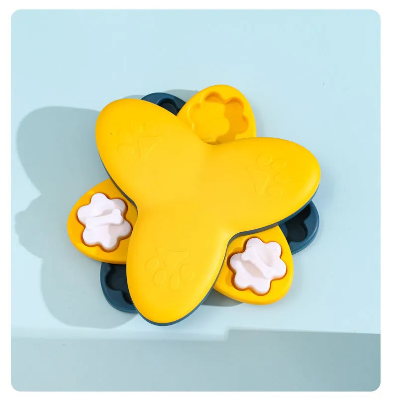 Green and yellow dog puzzle toy with bone covers and rotatable treat dispenser on non-slip base