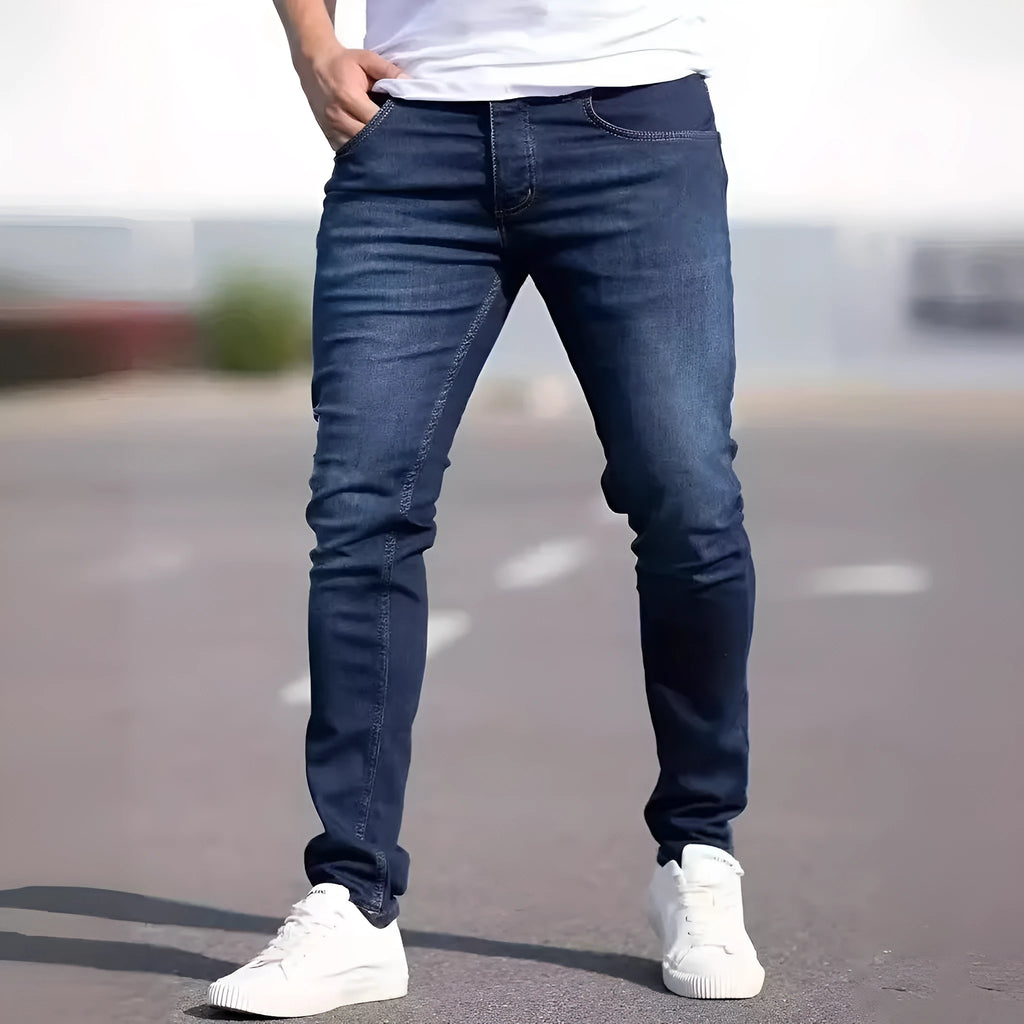 Dark blue men's slim fit skinny jeans with zipper fly on mid waist