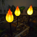 Solar simulation flame lamp with wrought iron frame and yellow flame effect in garden courtyard
