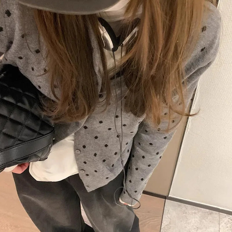 Women's grey dot knitted cardigan with crocheted flower detailing and long sleeves
