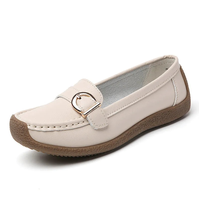 Women's beige casual loafers with round toe and flat heel on a light background.