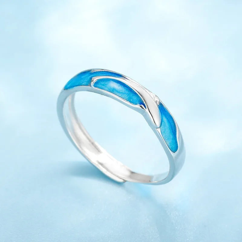 Silver adjustable couple ring with dolphin motif simple style on surface