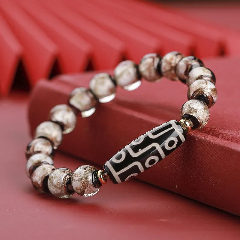 Close-up of a Chinese style coloured glaze bead bracelet with auspicious patterns, showing bead sizing options.