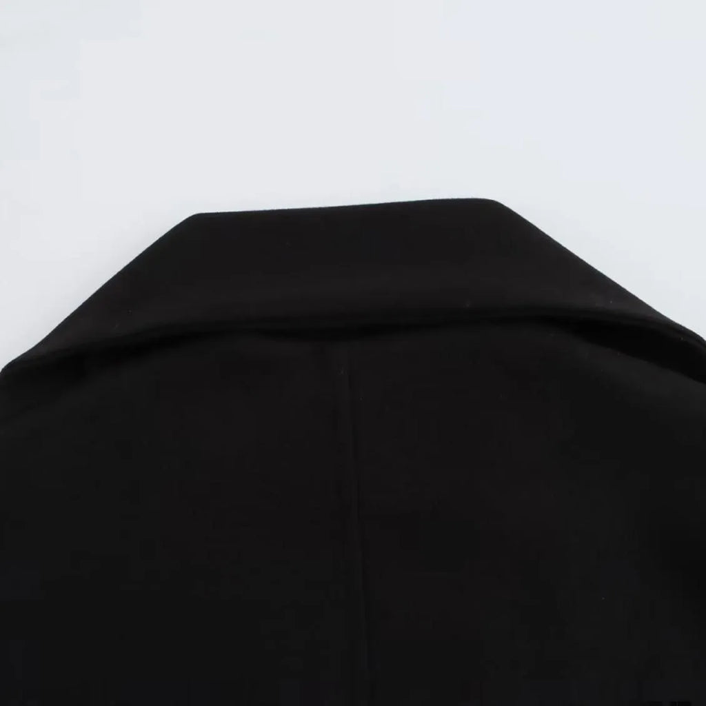 Women's long grey coat with an artificial fur collar, shown with pockets and a street fashion style.