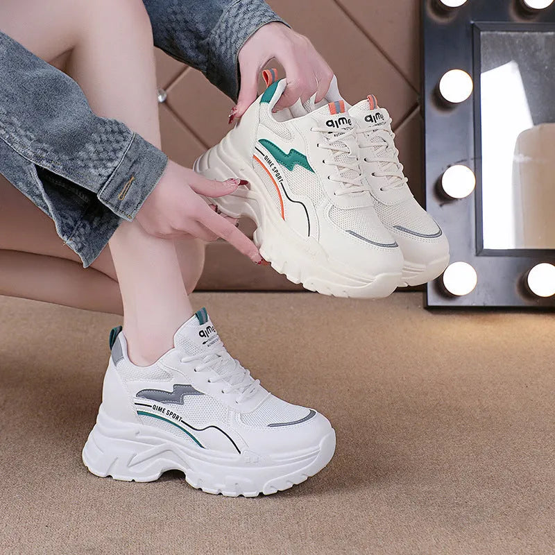 Women's white low-top sports dad shoes with cross strap and round toe, showcasing breathable mesh design.