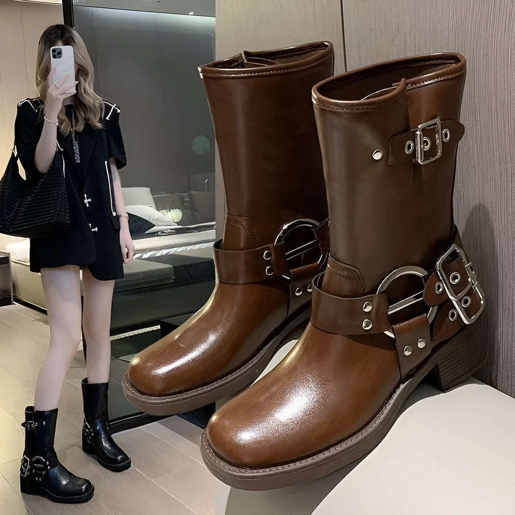 Women's black platform boots with buckle detailing showing middle calf length
