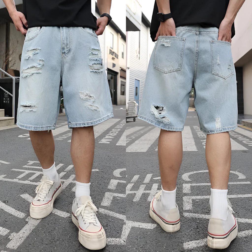 Light blue ripped denim shorts with distressed detailing and loose straight-leg cut