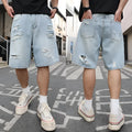 Light blue ripped denim shorts with distressed detailing and loose straight-leg cut