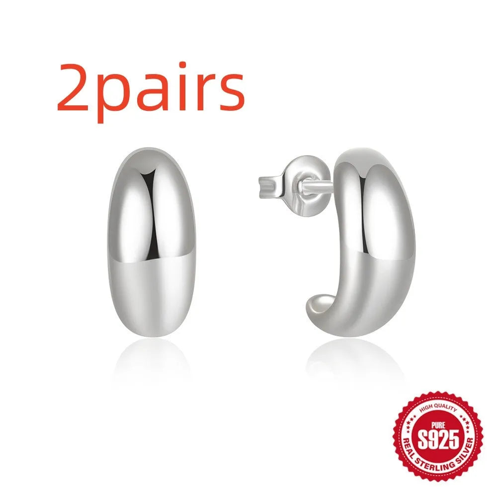 A pair of simple C-shaped ring stud earrings in 925 sterling silver, shown in both gold and silver colour options.
