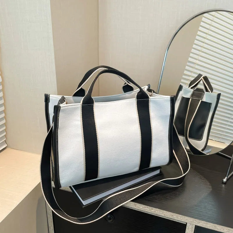 Women's canvas tote bag in horizontal square shape with open pocket, available in black