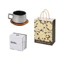 Gold-plated gift tumbler cup and box set on a desk