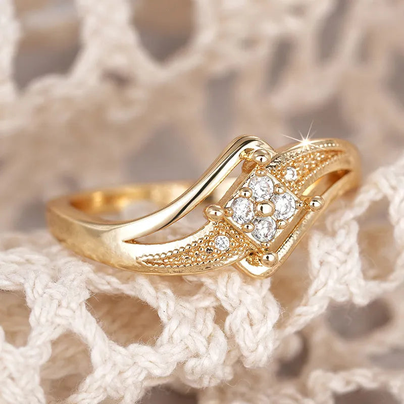 Yellow gold coloured copper diamond ring with geometric design and micro inlaid zircon detail.