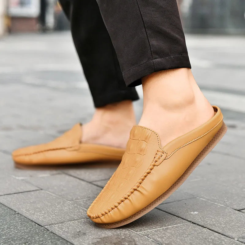 Men's black breathable Gommino semi-slippers with a rubber sole on a plain background