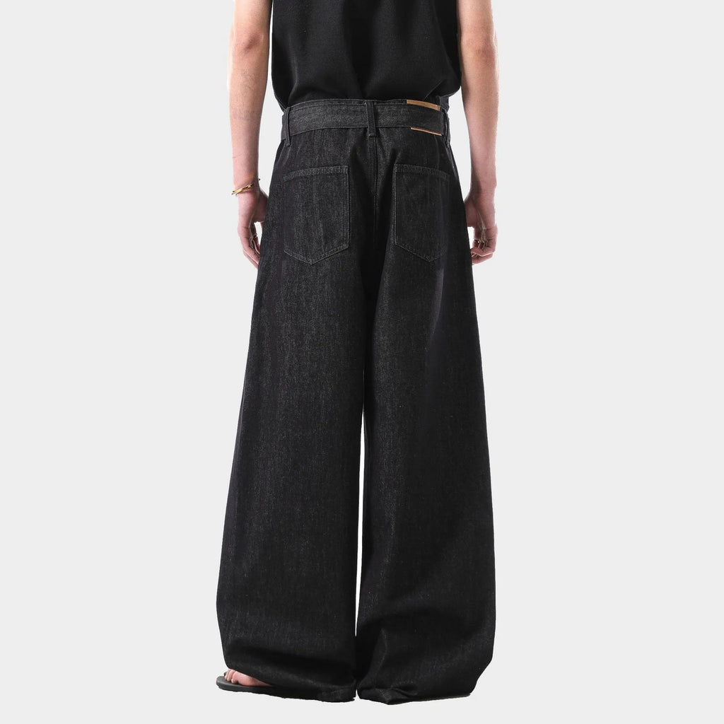 Black women's high waist straight leg jeans with gold detailing on a mannequin, showing the zip fly and classic denim cut.