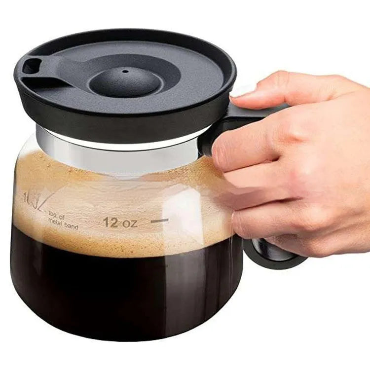 Transparent borosilicate glass coffee maker with silicone cover showing modern simple design