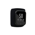 Black rechargeable electric heating ankle sleeve wrapped around an ankle