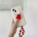 Red Christmas hat iPhone case with plush bracelet for iPhone 14, 13, 12 and 11 models, silicone back cover.