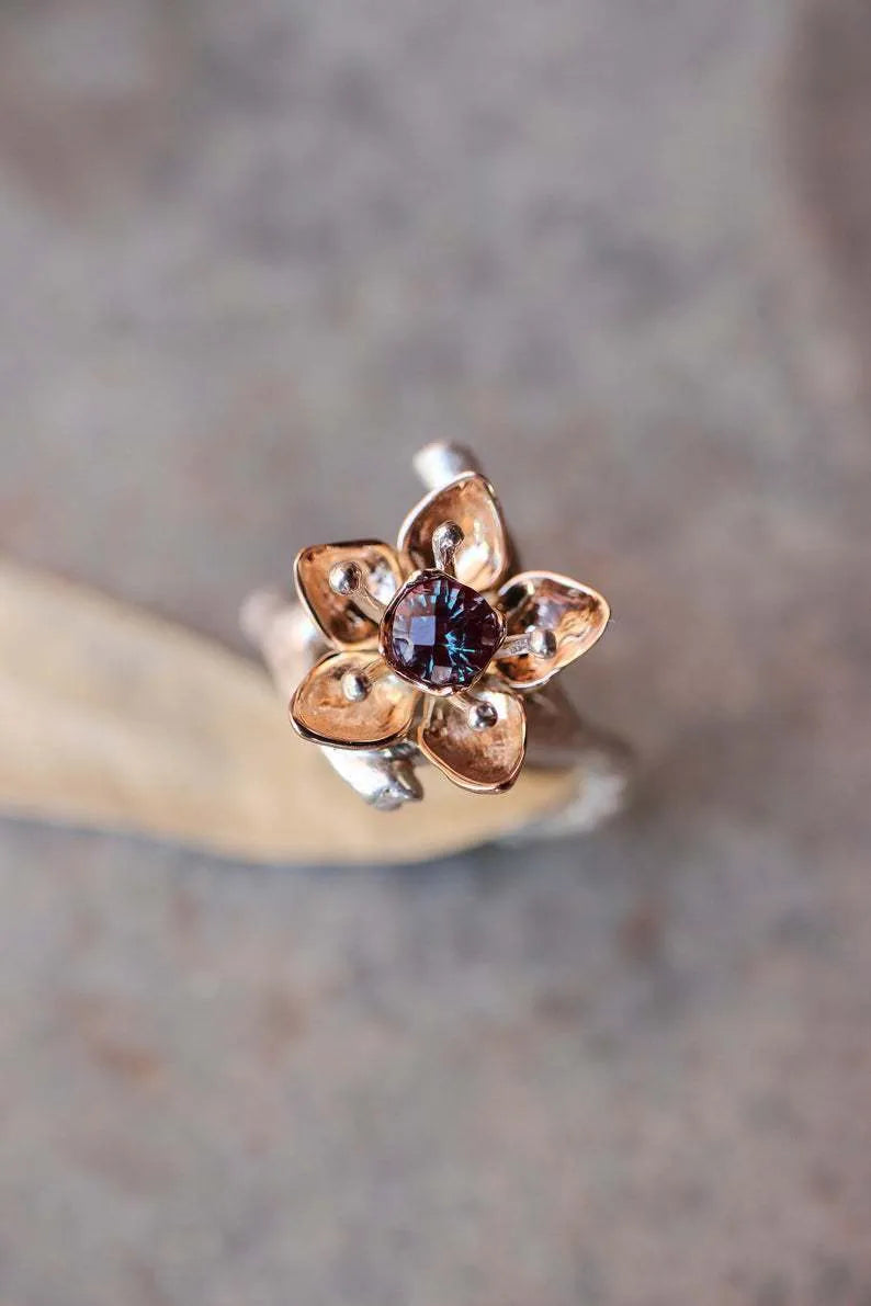 Silver two-tone floral design women's alloy ring on a geometric band.