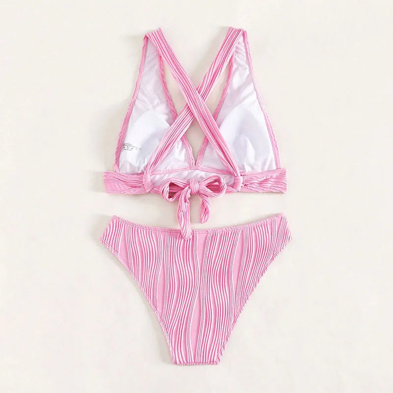 Women's pink and black halter strap bikini set with sleeveless top and shorts on a mannequin.
