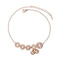 Rose gold stainless steel anklet with coin charms and small bells on adjustable link chain