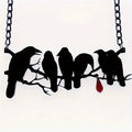 Black alloy crow pendant necklace with electroplated finish and cross chain, gothic bird jewellery.