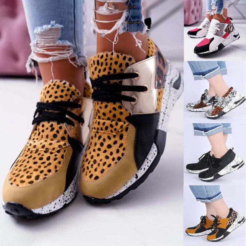 Women's black casual flat sneakers with suede upper and a wedge heel on a breathable fabric base.