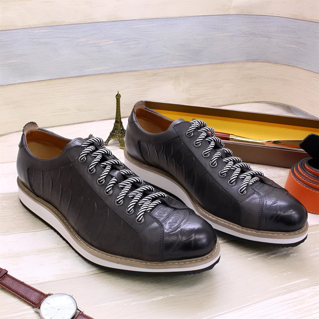 Men's handmade embossed pattern shoes in low tube design with front tie closure showing detail of pattern work