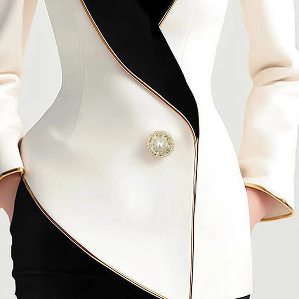 Milky white women's irregular long sleeve coat with golden edge pearl buttons on a hanger.