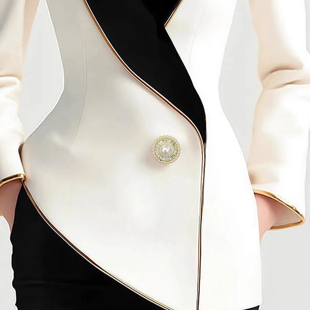 Milky white women's irregular long sleeve coat with golden edge pearl buttons on a hanger.