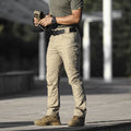 Men's loose cargo pants in cotton blend with multiple pockets, available in khaki, black and grey green.