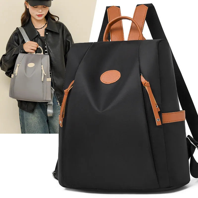 Waterproof Oxford cloth anti-theft travel backpack in black with sandwich pocket and zipper compartments