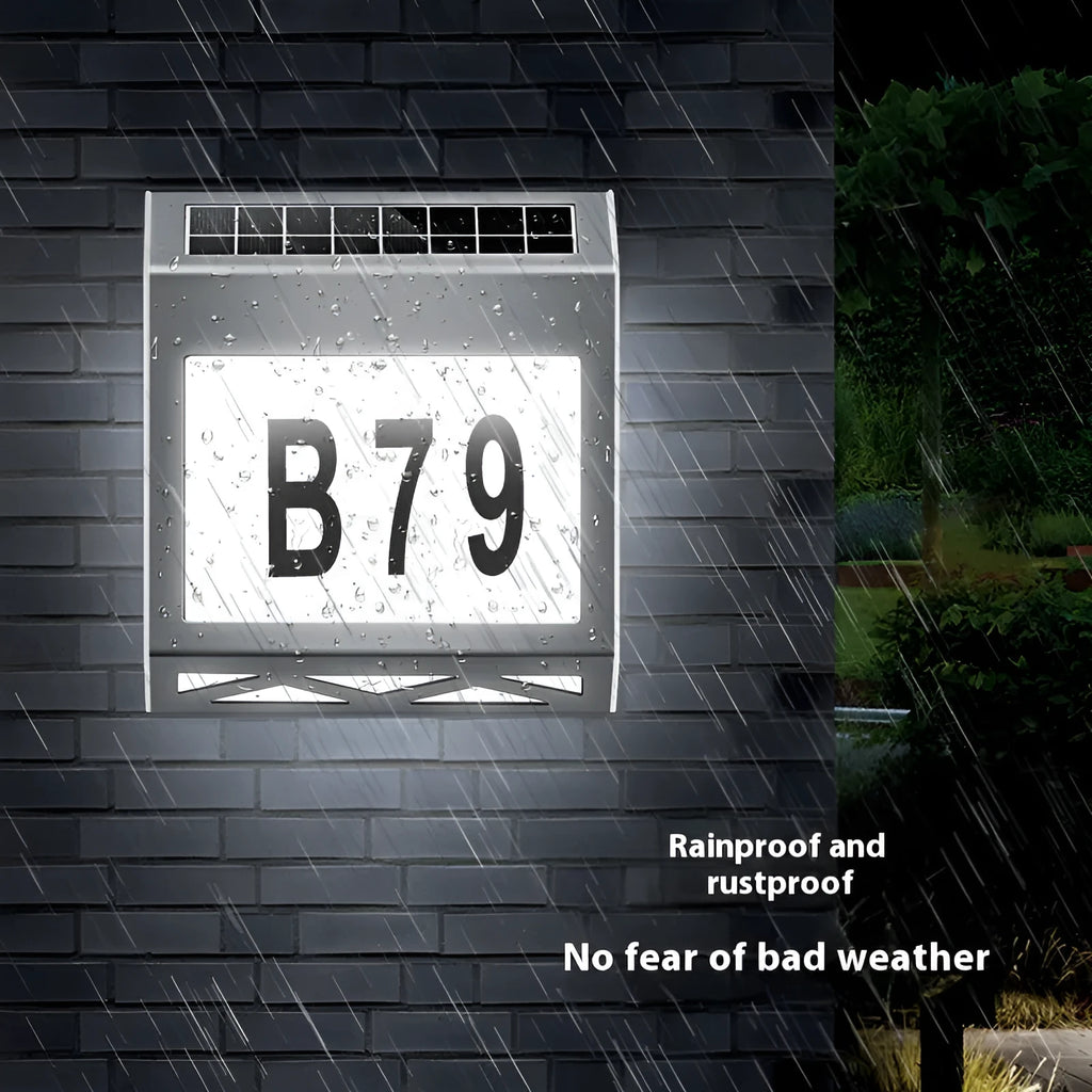 Black solar powered waterproof doorplate light with LED house numbers mounted on exterior wall