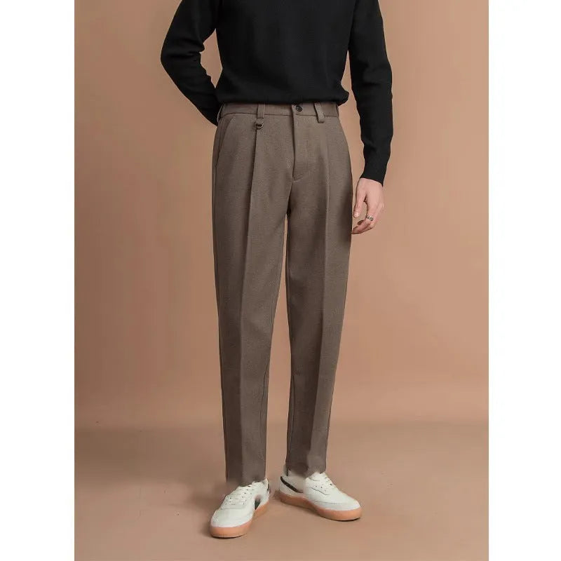 Man wearing straight-fit suit pants in a draped silhouette, suitable for business and casual occasions.