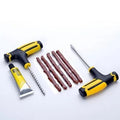 Vacuum tyre repair kit with black tools, rubber strips, and glue for motorcycle and car puncture repairs