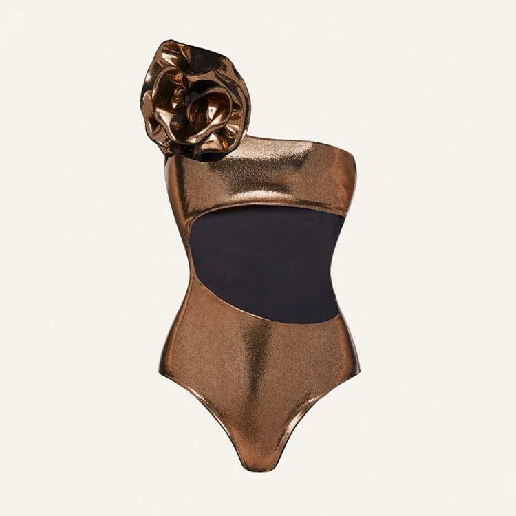 Gold coloured handmade one-piece swimsuit with halter neckline and hollow-out design on a mannequin.