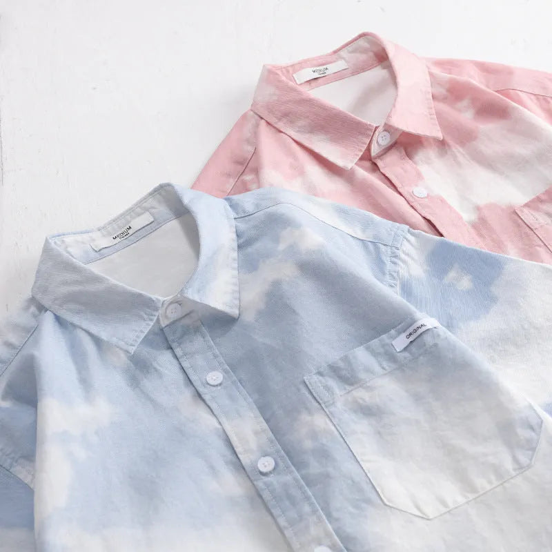 Men's light pink pure cotton short-sleeved shirt with a loose cardigan fit on a hanger.