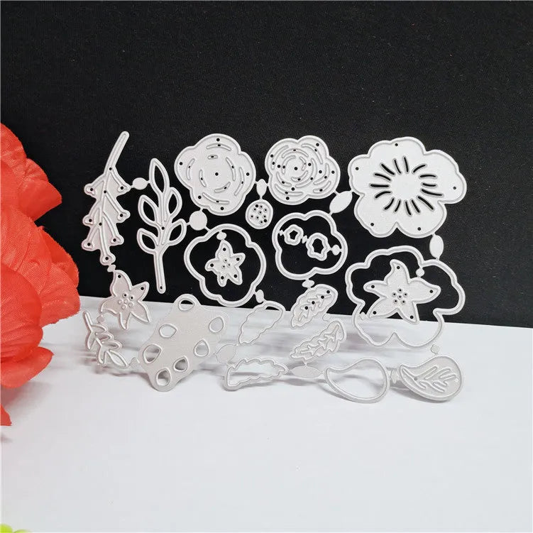 Silver carbon steel flower paper cutting die measuring 14.3 by 9.9 centimetres.