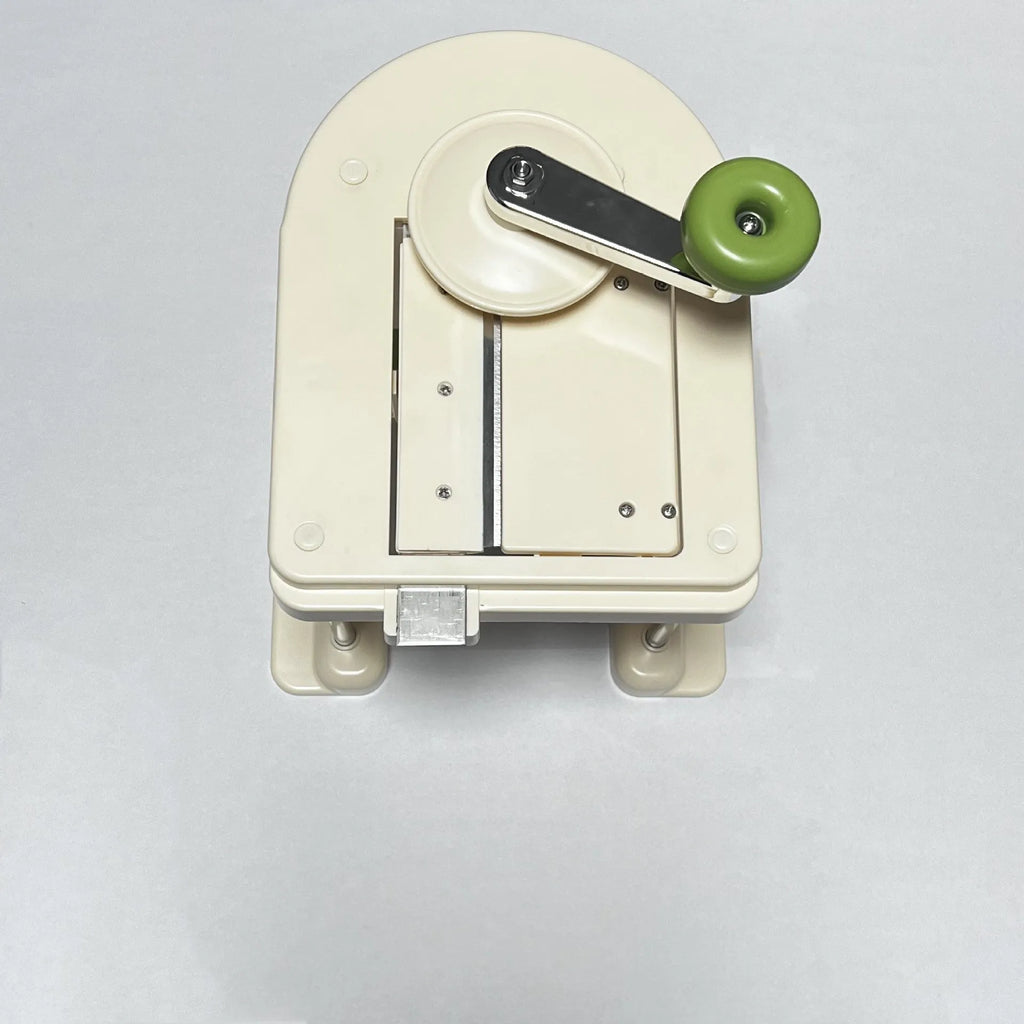 Beige stainless steel vegetable slicer and grater for kitchen use