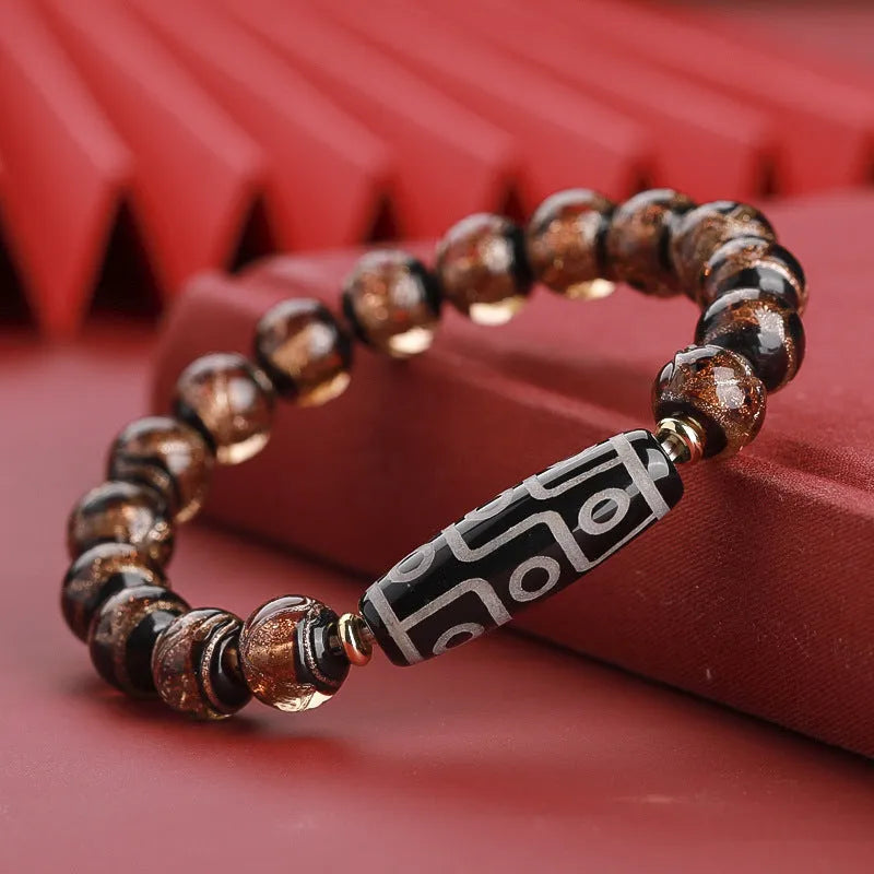 Close-up of a Chinese style coloured glaze bead bracelet with auspicious patterns, showing bead sizing options.