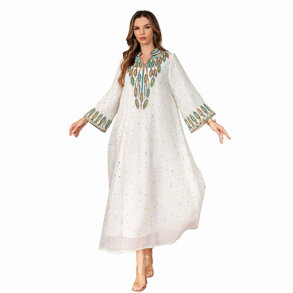 White polyester Arabic robe with long sleeves and full-length skirt on hanger