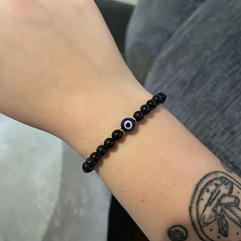 Men's black beaded bracelet with 8mm devil's eye beads and 6mm black beads in a geometric design.