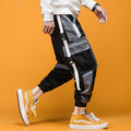 Men's loose fit hip hop beam pants in khaki cotton-rich fabric, mid waist, tether closure, small feet hem, available in black and white.