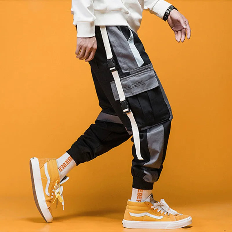 Men's loose fit hip hop beam pants in khaki cotton-rich fabric, mid waist, tether closure, small feet hem, available in black and white.