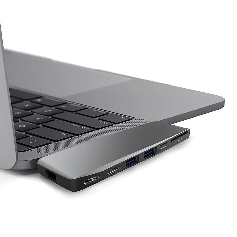 Silver 8-in-1 USB-C hub for MacBook Pro with dual connectors and multiple ports
