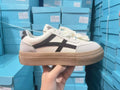 Blue low-top women's casual trainers with round toe and white rubber sole on a plain background.