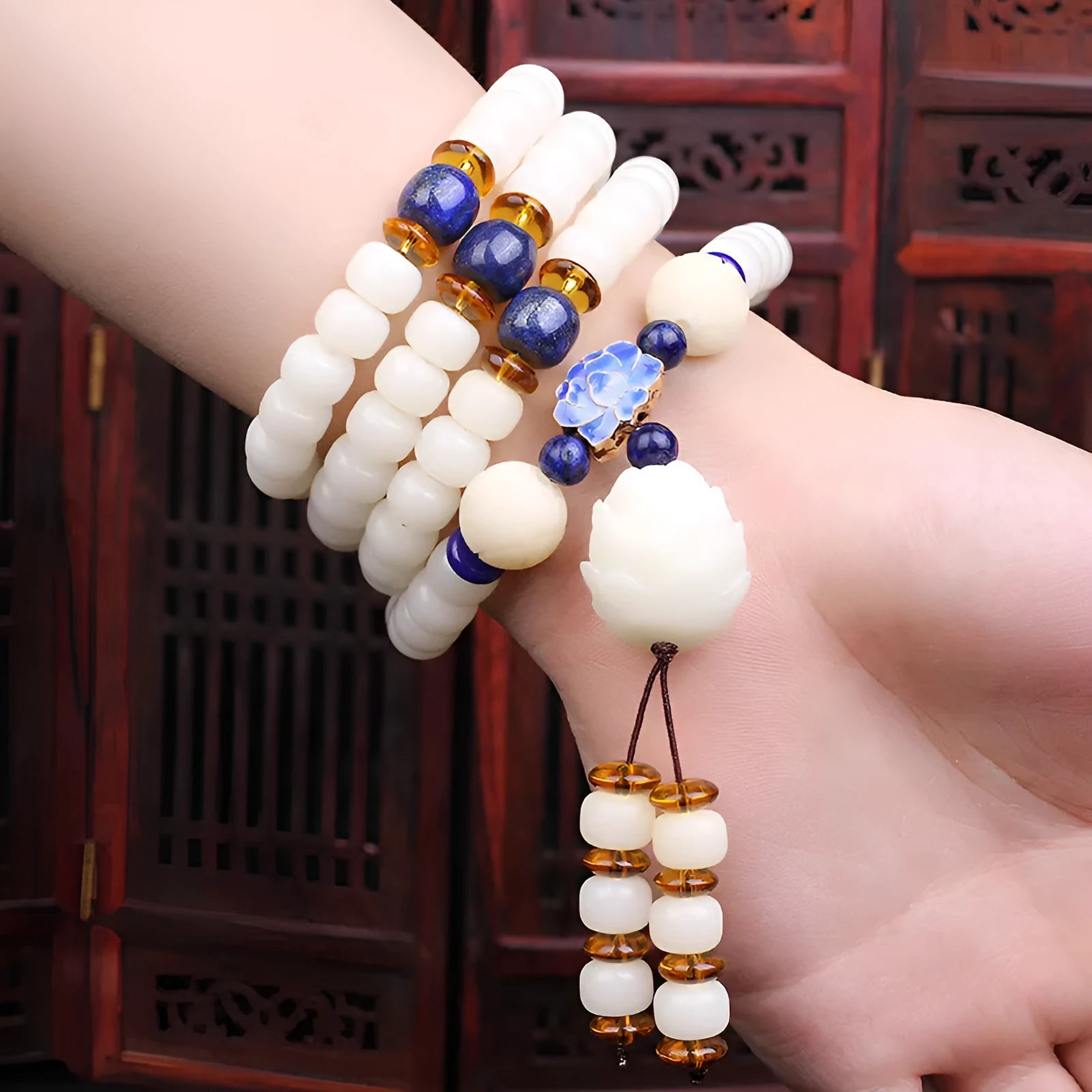 White jade Bodhi seed bracelet with 6x8mm beads in multiple styles including lotus and cloisonne designs.