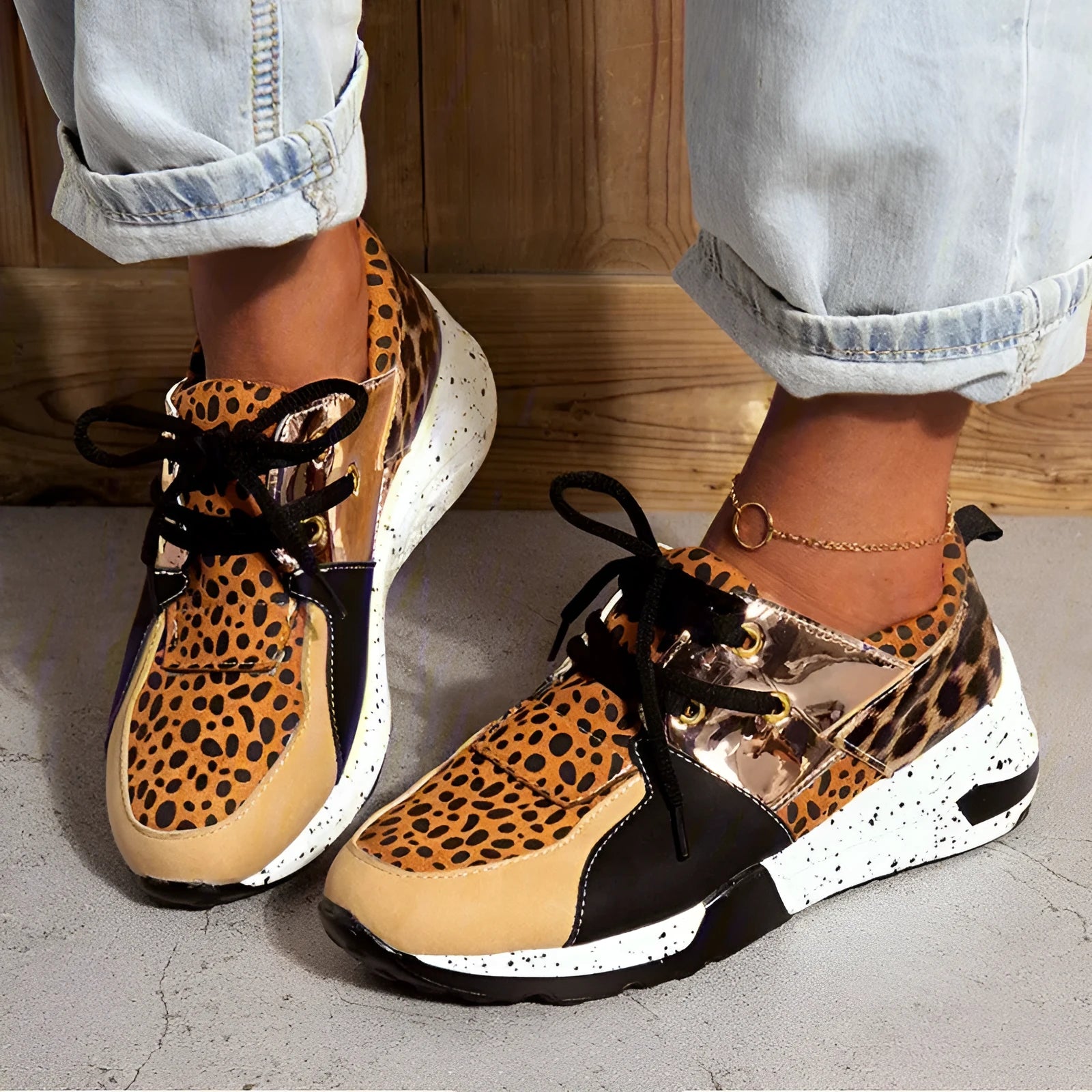 Women's black casual flat sneakers with suede upper and a wedge heel on a breathable fabric base.