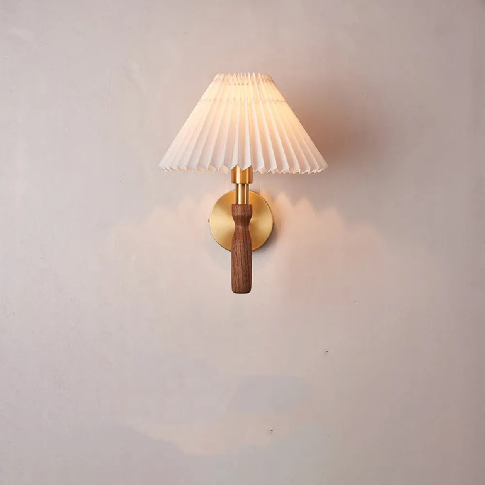 American retro rubber wood and fabric wall lamp in walnut finish on a wall.